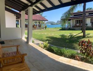 a porch of a house with a view of the water at Balong Balong Surf Bungalows & Restaurant in Sekongkang