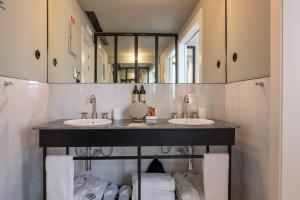 a bathroom with two sinks and a large mirror at Casa da Marechal - Boutique Hotel by Oporto Collection - Adults Only in Porto