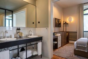a bathroom with two sinks and a large mirror at Casa da Marechal - Boutique Hotel by Oporto Collection - Adults Only in Porto