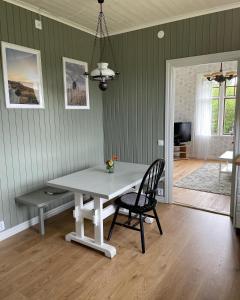 a dining room with a table and a chair at Pensionat Haga Öland in Löttorp
