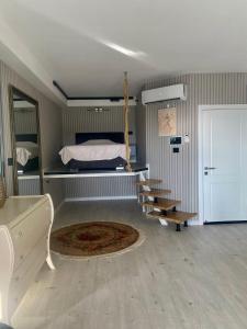 a bedroom with a bed and a table and chairs at Luxury open-space apartments by the sea in Ashdod