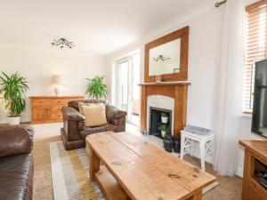 a living room with a couch and a table at Col du Crich in Matlock