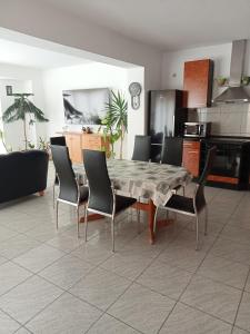 a dining room with a table and chairs at Apartman Laguna in Balatonlelle