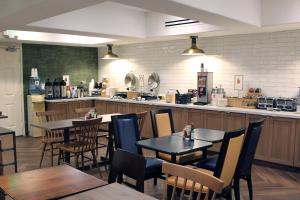 a restaurant with tables and chairs and a kitchen at Fairfield Inn & Suites by Marriott San Francisco San Carlos in San Carlos