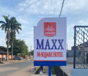 a sign for a masyx insurance hotel on a street at Maxx Msquare Hotel in Agege