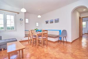 a living room with a table and chairs and a couch at Apartamento Son Bou Gardens in Son Bou