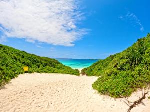a sandy beach with the ocean in the background at Happy Island Miyako in Miyako-jima