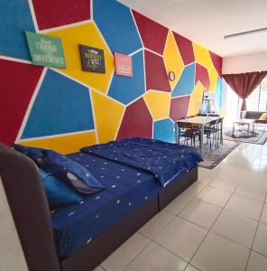 a room with a bed and a colorful wall at Nurul Aisyah Homestay in Tanah Rata