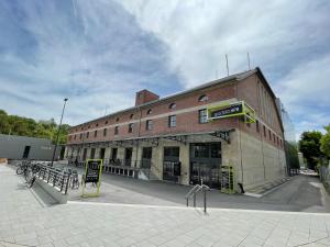 a large brick building with a sign in front of it at 60sqm "Piece of heaven" in Munich's south in Munich