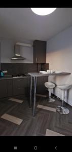 a kitchen with a table and two stools in it at Верховина in Uzhhorod +10 photos