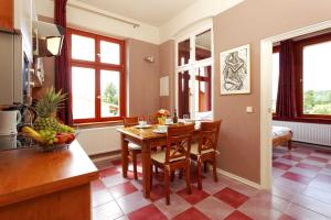 a kitchen and dining room with a table and chairs at Villa Maria Wohnung 07 in Ostseebad Koserow
