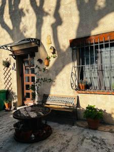 a bench sitting next to a building with a window at Charmant deux pièces au calme in Mougins