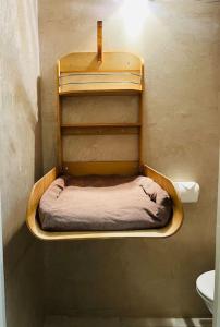 a shelf in the corner of a room with a toilet at Charmant deux pièces au calme in Mougins