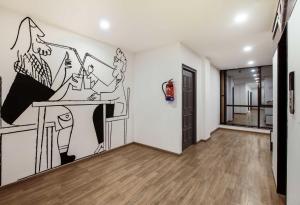 uma sala com um desenho na parede em OYO Townhouse 1099 Jp Grand Near Mayapuri Chowk em Nova Deli