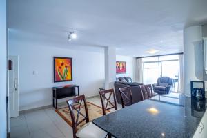 ein Wohnzimmer mit einem Tisch, Stühlen und einem Sofa in der Unterkunft 304A Santorini -Margate RSA in Margate