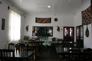 a dining room with tables and chairs and a tv at Rummy Hostal in Uyuni