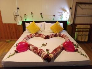 a bed with a heart made out of candy canes at Ravana Range Ella in Ella