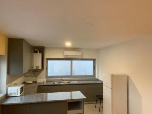 a kitchen with a sink and a window at Encostas do Côa TER -HOTEL in Pinhel