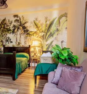 een slaapkamer met 2 bedden, een bank en een muurschildering van palmbomen bij The Tropical House Tirana in Tirana