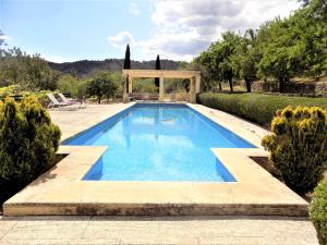 a swimming pool in a garden with a gazebo at Ca Nostra de Esporles Charming Estate at Esporlas for families in Esporlas