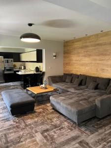 a living room with a couch and a table at Guest House EGO in Bratsigovo +25 photos
