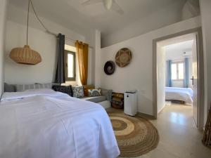 a bedroom with a bed and a living room at Maria’s Cottage House in Kalymnos