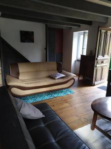 a couch sitting in the middle of a living room at Chez Gueguette in Saint-Jean-Saint-Gervais