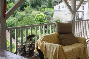 a pillow sitting on a chair on a porch at Bella Vista in Aubeterre-sur-Dronne
