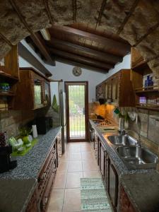 a kitchen with a sink and a counter top at L'Uliveto HOLIDAY HOUSE -Casa Vacanze Indipendente- in Muravera