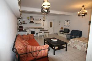 a living room with a couch and a table at Fourdeck Villa in Posidhonía