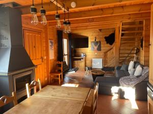 a living room with a couch and a fireplace at Chalet Résivacances n°32 - La Joue du Loup in Le Dévoluy