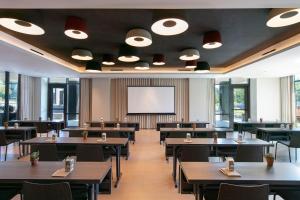 a dining room with tables and a projection screen at Hotel Citrine, Palo Alto, a Tribute Portfolio Hotel in Palo Alto +33 photos