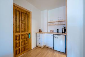 a kitchen with a wooden door and a counter top at Audo Studio in Antalya