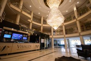 a large lobby with a large chandelier in a building at Vivaldi Park Hotel in Ankara