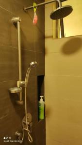 a shower in a bathroom with a green bottle at CQ1101- SELF CHECK-IN- WI-FI - NETFLIX-PARKING-BALCONY- CYBERJAYa, 2063 in Cyberjaya