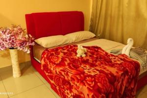 a red bed with a teddy bear sitting on it at CQ1101- SELF CHECK-IN- WI-FI - NETFLIX-PARKING-BALCONY- CYBERJAYa, 2063 in Cyberjaya