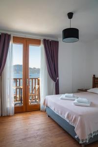 a bedroom with a bed and a view of the ocean at Alice Tatil Evi in Marmaris