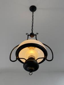 a chandelier hanging from a ceiling at Oranuisce Thatch Cottage Ballyvaughan in Ballyvaughan