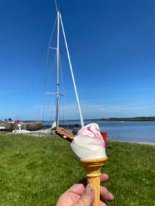 a person holding an ice cream cone with a stick at Oranuisce Thatch Cottage Ballyvaughan in Ballyvaughan