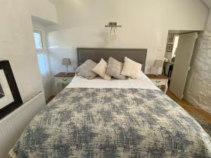 a bedroom with a large bed and two night stands at Oranuisce Thatch Cottage Ballyvaughan in Ballyvaughan