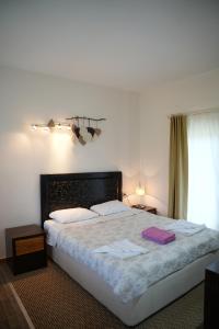 a bedroom with a bed with two towels on it at Sofia Residence in Kemer