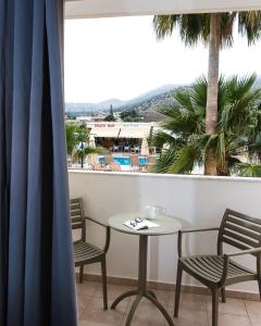 a table and chairs on a balcony with a view at Newcastle Studios by Estia in Malia