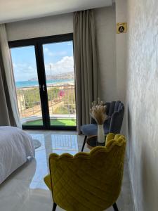 a bedroom with a bed and a view of the ocean at Bella Address Hotel Beach in Saïdia