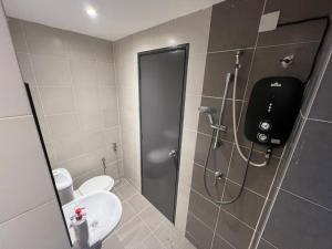 a bathroom with a shower with a toilet and a sink at Villa 8812 极简风民宿 舒适现代风 in Kampong Sungai Udang +14 photos