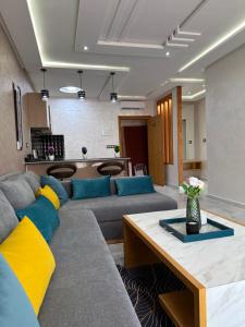 a living room with a couch and a table at Bella Address Hotel Beach in Saïdia