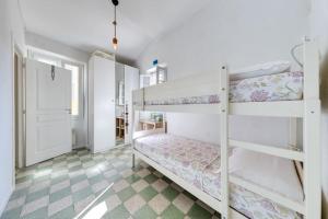 a bedroom with two bunk beds and a window at Between the roofs of Menton old town and the sea in Menton