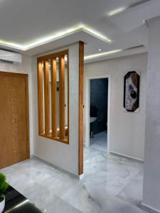a room with a hallway with a mirror and a door at Bella Address Hotel Beach in Saïdia