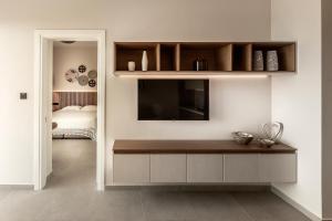 ein Wohnzimmer mit einem TV an der Wand in der Unterkunft Anemi Hotel & Suites in Paphos City