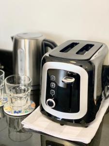 a black and white toaster sitting on a counter at Le Bijou Chic in the Heart of Saigon Charm with VIEW in Ho Chi Minh City