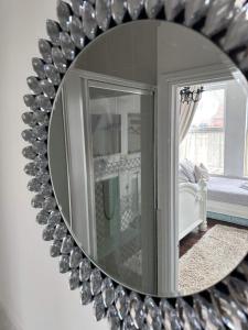 a mirror with a reflection of a living room at Baytree House in Lowestoft